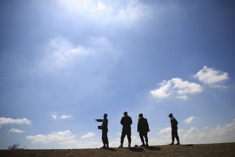 U.N. peacekeepers from the United Nations Disengagement Observer Force observe Syria's Quneitra province from Mt. Bental in the Israeli-controlled Golan Heights. Today, there are more than 100,000 U.N. peacekeepers, uniformed and civilian, in the field. (Tsafrir Abayov / AP)