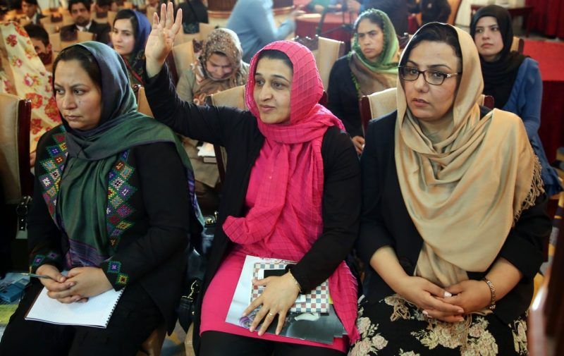 Executive Director for Afghan women’s Network (AWN), Hasina Safi, center, raises her hand to ask a question during a press conference by Amnesty International. (Massoud Hossaini/AP)