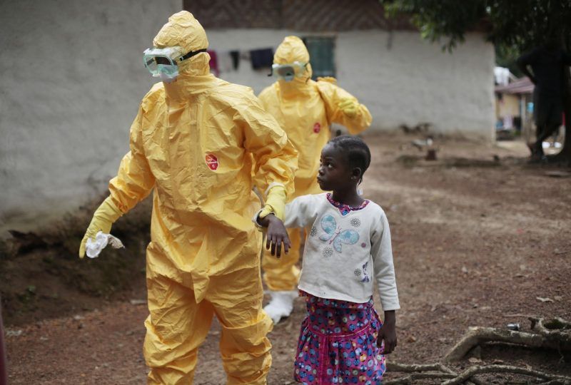 Nine-year-old Nowa Paye is shown last year being taken to an ambulance in her village in Liberia after showing signs of the Ebola infection. (Jerome Delay/Associated Press)