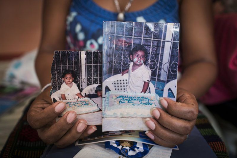  July Elizabeth Pérez holds a photo of her son Anthony Yalibath Pacheco, who was killed in Honduras by gangs last year when he was 14 years old. Credit Katie Orlinsky for The New York Times 