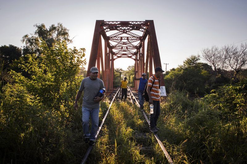 People head north in Chahuites, Mexico. It is one of the most dangerous areas along the southern migrant trail, where people are preyed on by criminals and fear officials monitoring the trains. Credit Katie Orlinsky for The New York Times