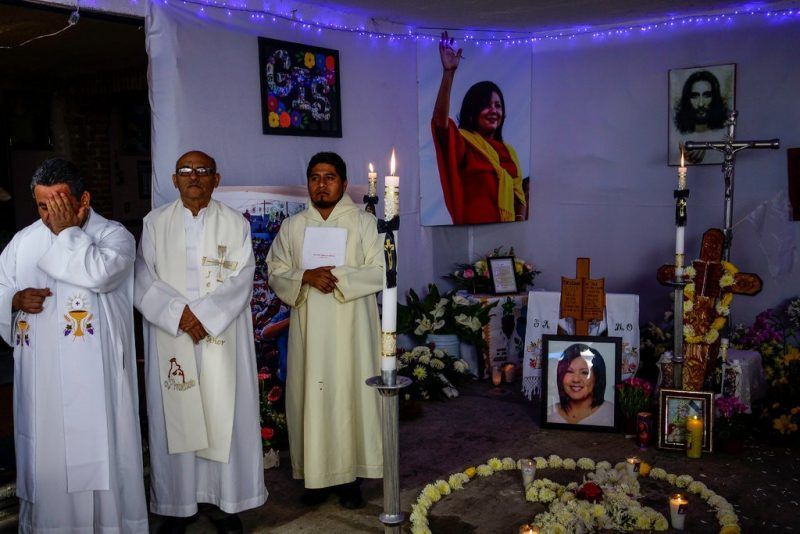 Priests officiate a mass for Ms. Mota at the family’s home in Temixco.Credit Adriana Zehbrauskas for The New York Times