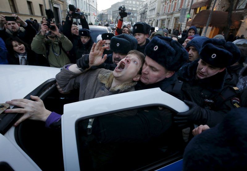 Police officers detain an activist who was taking part in a rally of foreign currency mortgage holders, near the Central Bank headquarters, Moscow, Russia, February 8, 2016. Sergei Karpukhin TPX Images of the Day/Reuters