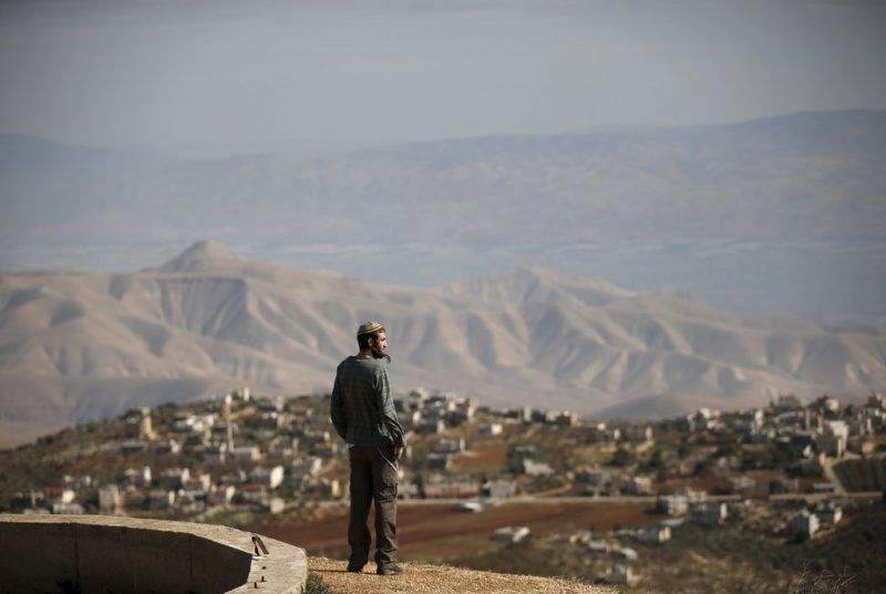 In January, a Jewish settler looked over the West Bank village of Duma. Credit Ronen Zvulun/Reuters