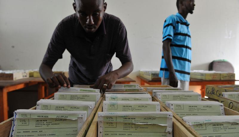 A Djiboutian electoral agent searches for a voter card at a polling station on 22 March 2016. Photo by Getty Images.