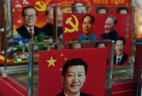 Decorative plaques featuring Chinese leaders of the past and present, including current president Xi Jinping (front), are seen at a souvenir stall in Beijing in 2014. (Greg Baker/Agence France-Presse via Getty Images)