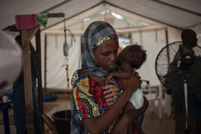 A woman holds her young baby during a check-up at the In-Patient Therapeutic Feeding Centre in the Gwangwe district of Maiduguri, the capital of Borno State, northeastern Nigeria, on September 17, 2016. Aid agencies have long warned about the risk of food shortages in northeast Nigeria because of the conflict, which has killed at least 20,000 since 2009 and left more than 2.6 million homeless. STEFAN HEUNISSTEFAN HEUNIS/AGENCE FRANCE-PRESSE via Getty Images