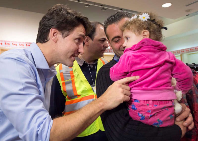 Prime Minister Justin Trudeau greeted Madeleine Jamkossian, right, and her father, Kevork Jamkossian, after the Syrian refugees arrived in Toronto in December. Nathan Denette/The Canadian Press via Associated Press