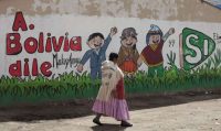 An Aymara woman walks past a mural that reads in Spanish “Tell Bolivia Yes,” in favor of President Evo Morales, in El Alto, Bolivia, in February, days before a referendum on whether to amend the constitution so that Morales could run in 2019 for a fourth consecutive term. (Juan Karita/Associated Press)