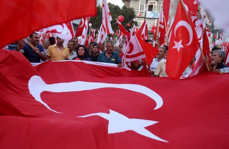Turkish Cypriot demonstrators wave Turkish and Turkish Cypriot flags during a mass rally in support of Turkey’s Prime Minister Recep Tayyip Erodgan following a failed coup that aimed to oust him. Peace talks aimed at reunifying north and south Cyprus resume Jan. 8. (Philippos Christou/Associated Press)