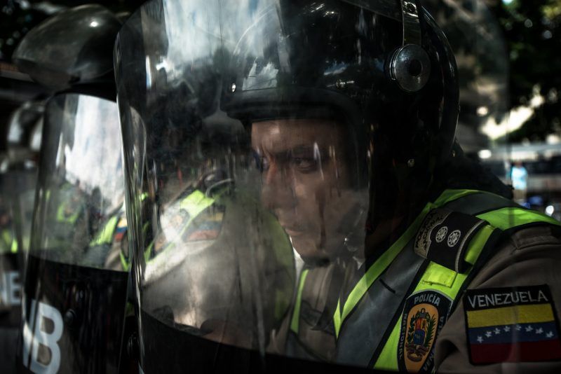 Police officers at an antigovernment protest in Caracas, Venezuela, in October. Meridith Kohut for The New York Times