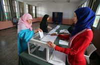 A woman casts her ballot in Algeria’s 2014 presidential election at a polling station in Algiers. (Mohamed Messara/European Pressphoto Agency)