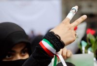 A veiled Iranian woman supporting conservative presidential candidate Ebrahim Raisi wears a picture of him on her finger during an election campaign rally in Tehran on May 16. (Abedin Taherkenareh/European Pressphoto Agency)