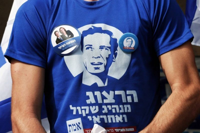 A supporter of the center-left Zionist Union wears a T-shirt showing Isaac Herzog, one of the party’s leaders, outside a polling station in Tel Aviv in 2015. (Baz Ratner/Reuters)