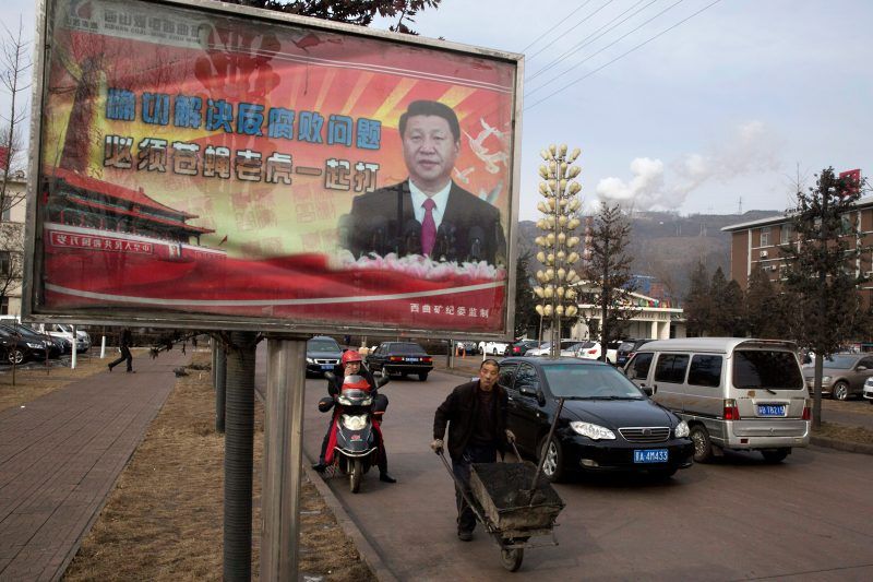 Ng Han Guan/AP Images. A billboard showing Chinese President Xi Jinping with the slogan, “To exactly solve the problem of corruption, we must hit both flies and tigers,” Gujiao, China, February 2015