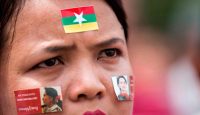 A woman attends a broadcast of the live speech of Myanmar's State Counselor Aung San Suu Kyi at City Hall in Yangon on September 19, 2017. Photo: Aung Kyaw Htet/AFP/Getty Images