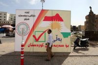 A man walks next to a poster in Irbil, in the Iraqi region of Kurdistan, that calls on Kurds to vote for independence on the eve of the Sept. 25 referendum. (Mohamed Messsara/European Pressphoto Agency/EFE)