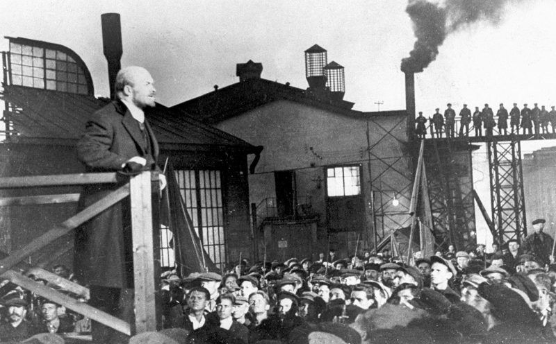 Bolshevik leader vladimir ilyich lenin (l) addressing crowd of factory workers during october revolution.