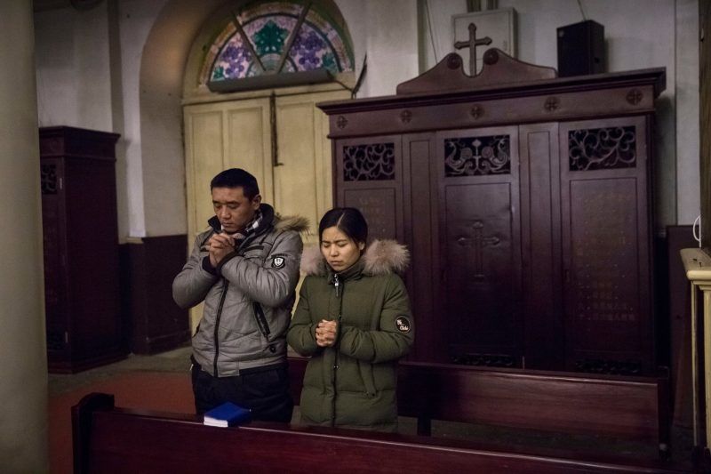 Catholics praying in Beijing on Jan. 30, two days before new repressive regulations of religion went into force in China. Credit Roman Pilipey/European Pressphoto Agency