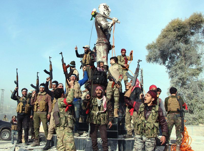 Turkish-backed Syrian National Army fighters preparing to destroy a statue of Kaveh, a heroic figure in Kurdish mythology, in Afrin, Syria, March 18, 2018