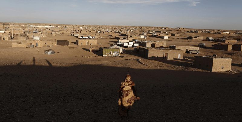An indigenous Sahrawi woman walks at a refugee camp of Boudjdour in Tindouf, southern Algeria, on 3 March 2016. REUTERS/Zohra Bensemra