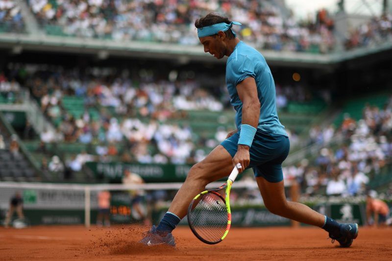 Rafael Nadal sliding in the clay during the 2018 French Open. Credit Christophe Archambault/Agence France-Presse — Getty Images 