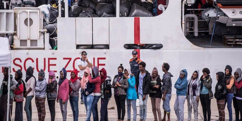 Migrants disembark the Italy's coastguard ship Diciotti at the port of Catania. Fabrizio Villa/Getty Images