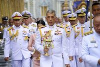 Thai King Maha Vajiralongkorn, center, holds a light during Wesaka Bucha, the most important Buddhist holy day of the year, at a temple in Bangkok last month. (The Nation/Pool Photo via AP)