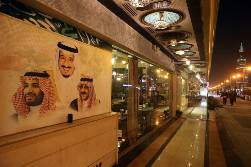 Portraits of Crown Prince Mohammed bin Salman, left, King Salman bin Abdulaziz and former Crown Prince Mohammed Bin Nayef on the wall of a restaurant in Riyadh, Saudi Arabia. Credit Jordan Pix/Getty Images