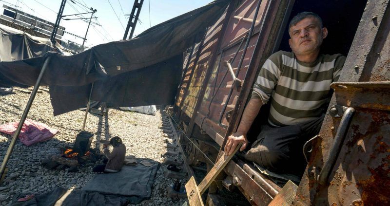 Un hombre en el interior de un vagón de tren abandonado en el campo de refugiados e inmigrantes de Idomeni, Grecia. JOE KLAMAR (AFP)