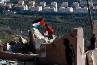 Demonstrators placed a Palestinian flag on top of a house in the West Bank village of Nabi Saleh during clashes with Israeli security forces in January. Credit Abbas Momani/Agence France-Presse — Getty Images