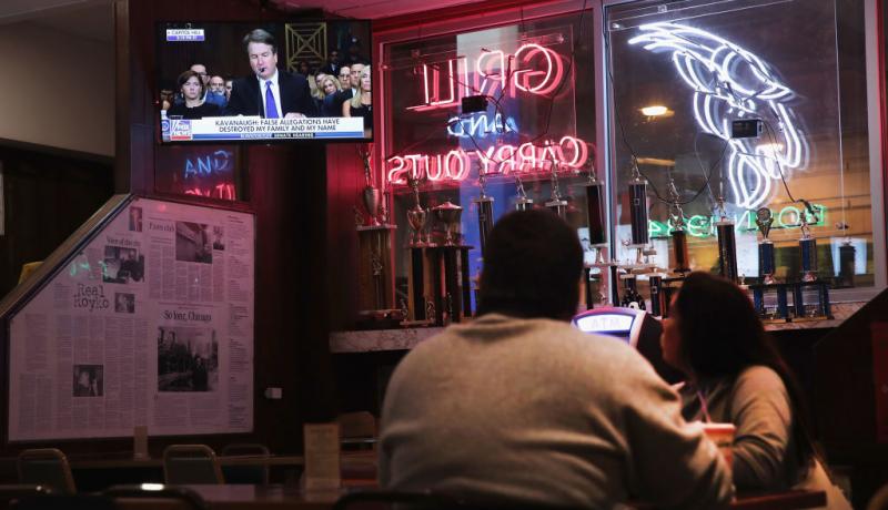 People watch the Kavanaugh hearings at a tavern in Chicago. Photo: Getty Images. 