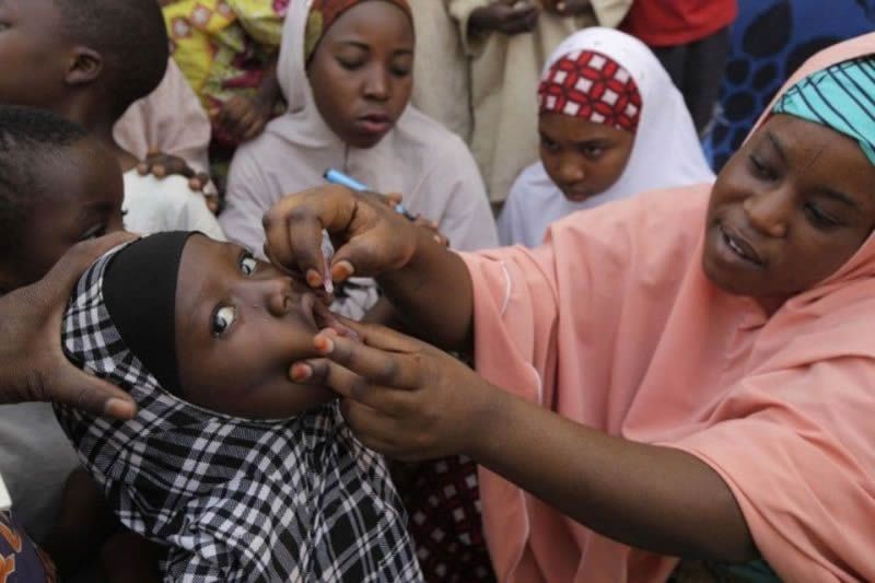 A health official administers a polio vaccine in 2014 in Nigeria, one of the few countries in the world where the wild polio virus remains endemic. (Sunday Alamba/Associated Press) 