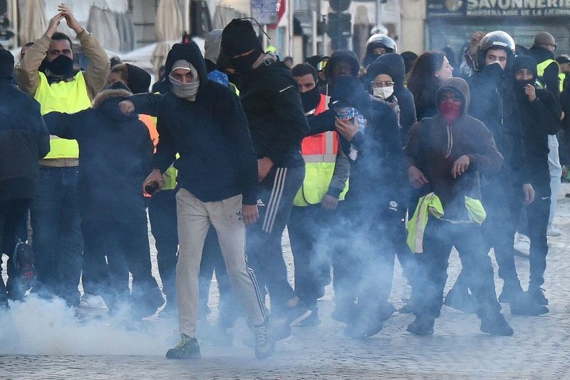 "Yellow vest" protesters with riot police members in Marseille, France, on Saturday. (Boris Horvat/AFP/Getty Images)