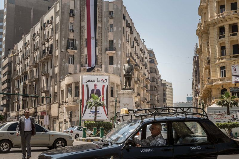 A Cairo intersection with a poster of President Abdel Fattah el-Sisi. The heads of state change in Egypt, but the repressive structures stay the same, Nancy Okail writes. Credit Sima Diab/Bloomberg