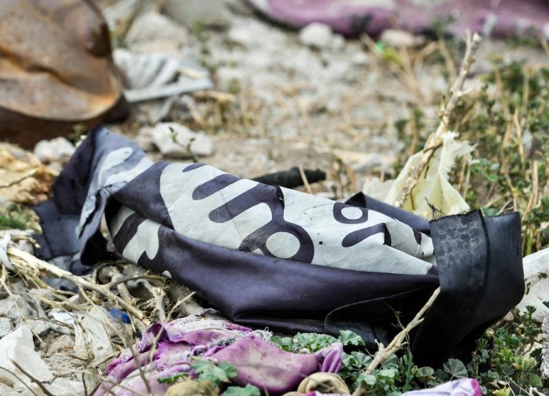 A discarded Islamic State flag in Baghuz, eastern Syria, on Monday. Credit Giuseppe Cacace/Agence France-Presse — Getty Images