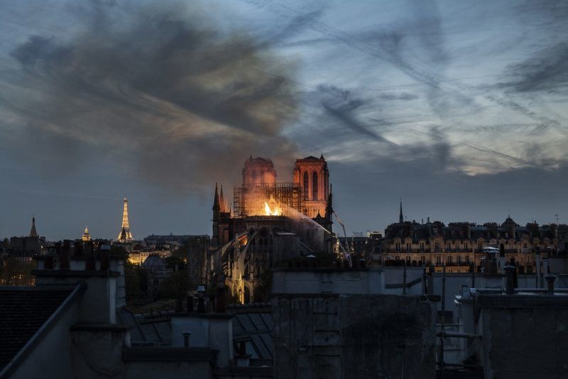 Flames and smoke are seen billowing from the roof at Notre Dame Cathedral in Paris on Monday. (Veronique De Viguerie/Getty Images)