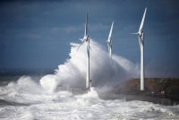Waves crash against power-generating windmill turbines during a windy day in Boulogne-sur-Mer, France. (Pascal Rossignol/Reuters)