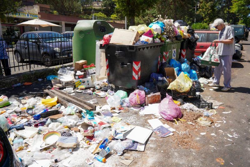 An overflowing trash bin in Rome on June 24. (Andrew Medichini/AP)