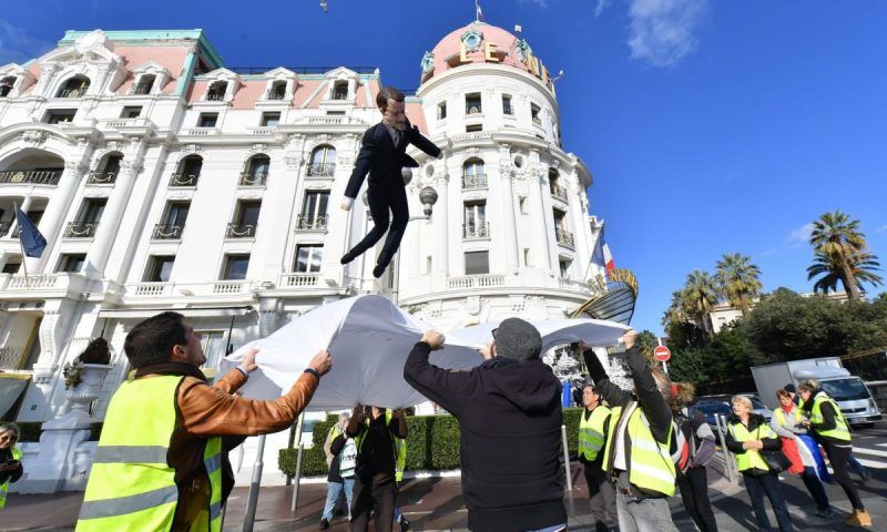 An effigy of Emmanuel Macron is thrown into a sheet during a gilets jaunes protest in Nice. Photograph: Yann Coatsaliou/AFP/Getty Images