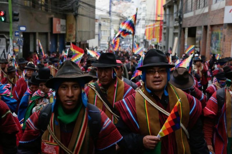 Supporters of Evo Morales wearing traditional ponchos and holding Wiphala flags take part in a protest on Nov. 14 in La Paz, Bolivia. (Getty Images)
