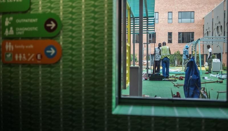 Builders work on an outside yard at the Nelson Mandela Children's Hospital in Johannesburg in 2016. Photo: Getty Images. 