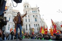 Santiago Abascal, leader of the Vox party, waves at a rally in Madrid on Jan. 12 protesting the new coalition government of Spanish Prime Minister Pedro Sánchez. (Jon Nazca/Reuters)