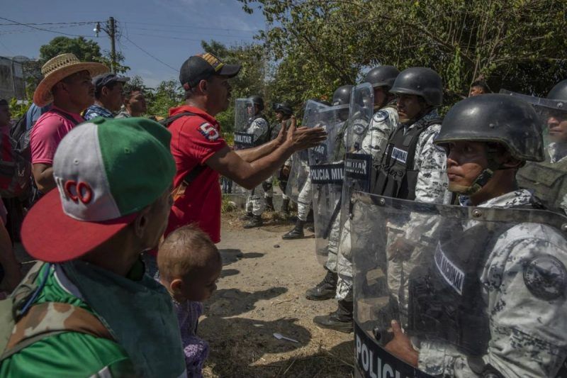 Members of the Mexican National Guard try to block entry to arriving Central American migrants crossing from the Suchiate River in the southern state of Chiapas on Jan. 20. (Alejandro Cegarra/Bloomberg)