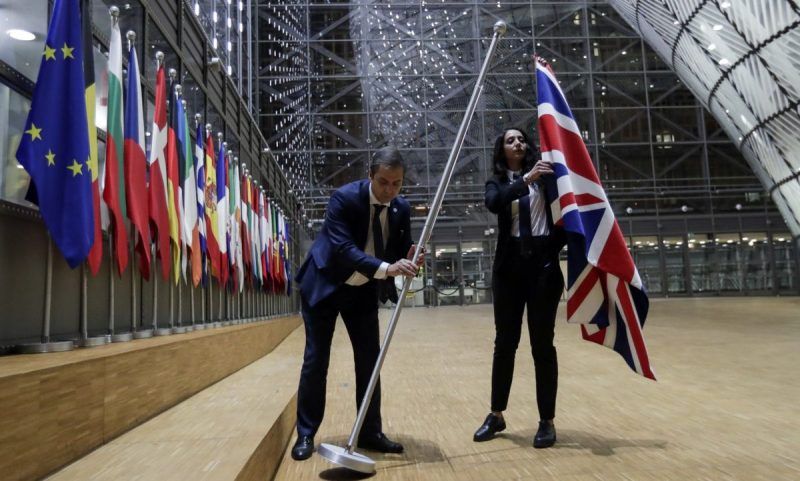The union jack is removed from the European Council in Brussels. Photograph: Olivier Hoslet/Pool/EPA