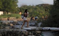 A woman crosses illegally into Colombia from Venezuela on May 1, 2019. (Fernando Vergara/AP)