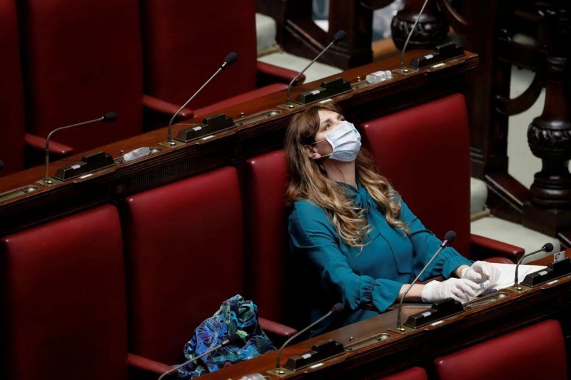 Maria Teresa Baldini of the far-right Fratelli d’Italia (Brothers of Italy) party wears a protective mask and gloves inside parliament after Italy’s lockdown. Photograph: Remo Casilli/Reuters