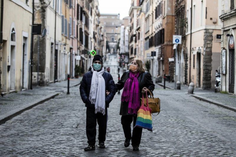 People wearing protective face masks walk in the Borgo Pio district in Rome on Tuesday. (Angelo Carconi/EPA-EFE/REX/Shutterstock)