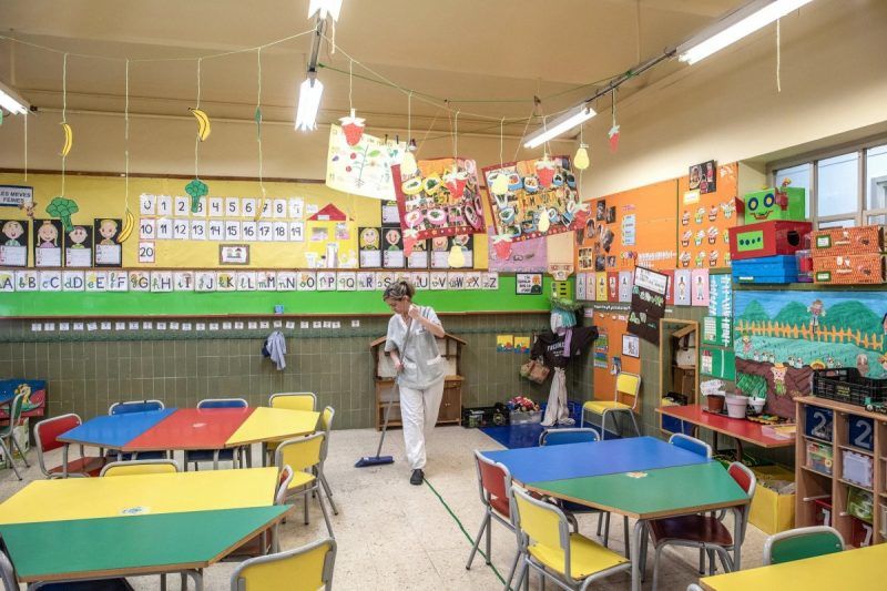 An empty classroom in Barcelona was cleaned on Thursday after schools and universities there closed to contain the virus.