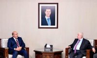 Syria’s foreign minister, Walid al-Moallem, meets Libya’s eastern government deputy prime minister, Abdul Rahman al-Ahiresh. Photograph: SANA